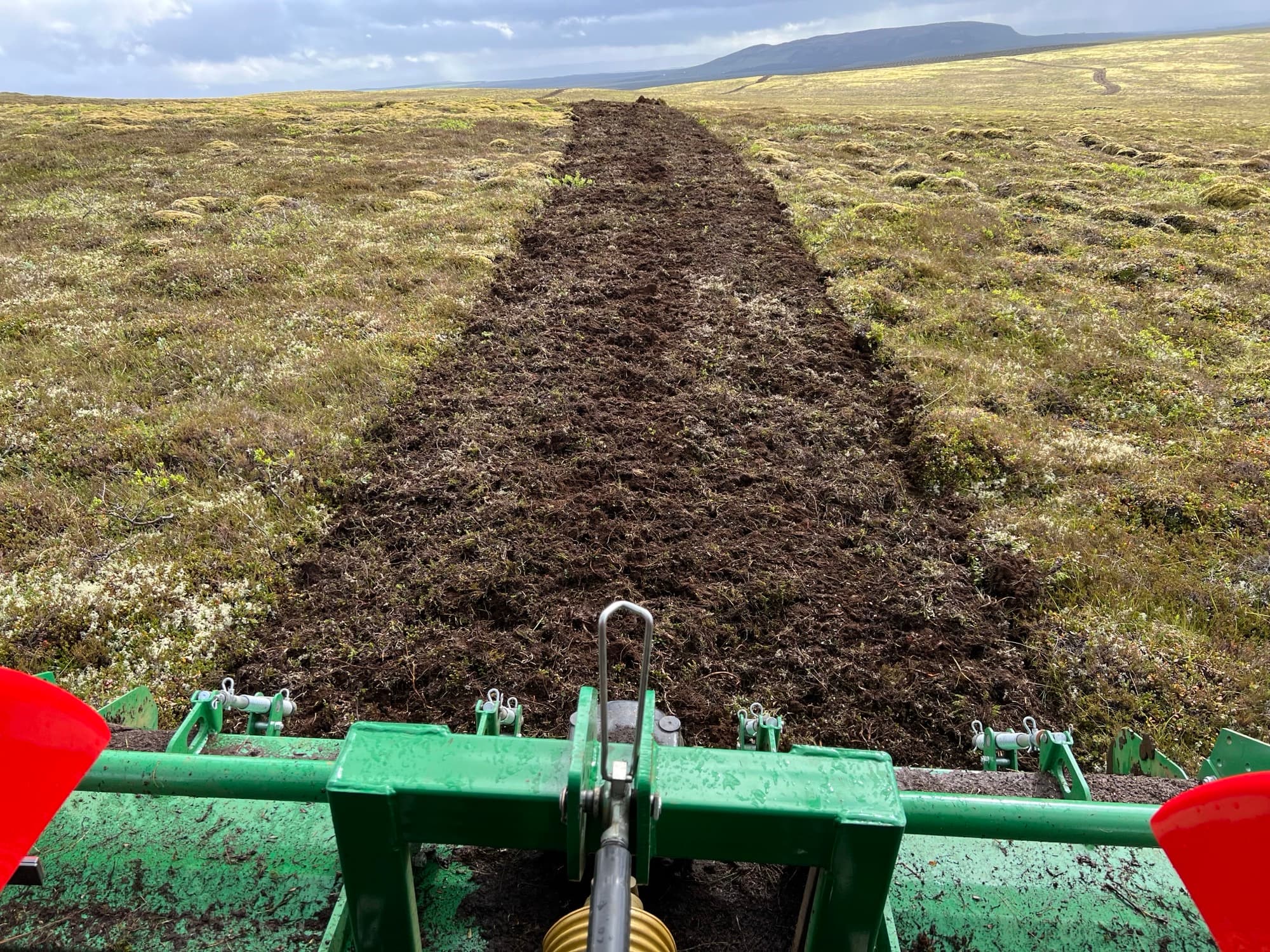 Soil preparation with a tractor-mounted plough